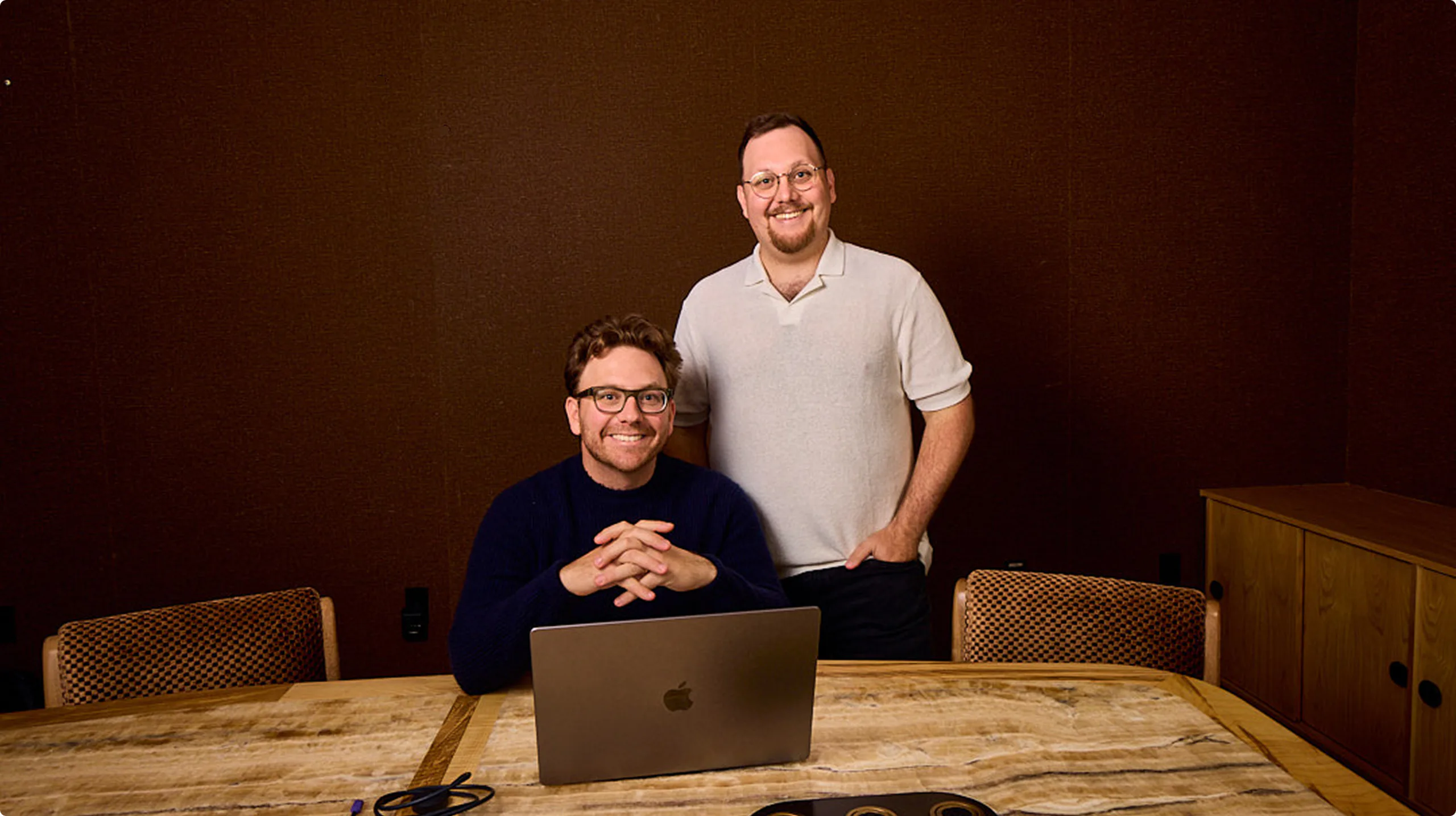 Matt and Nick Basile at a table with a laptop